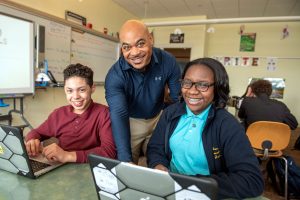 A Milton Hershey School high school teacher works with technology in the classroom.