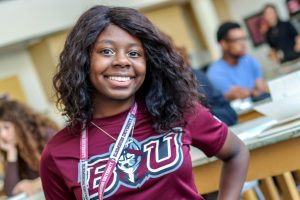 A Milton Hershey School young alumna wears a college t-shirt.
