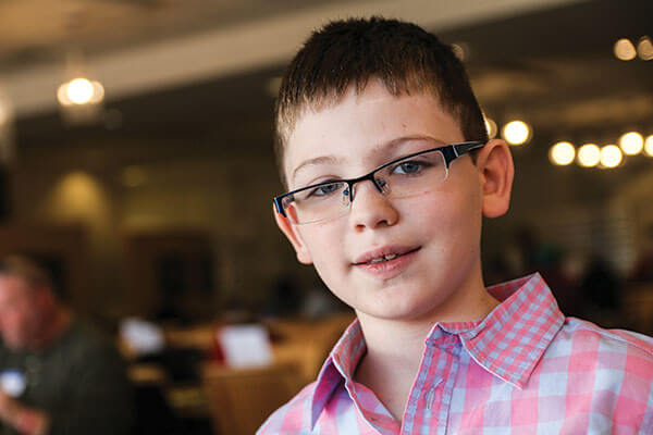 Photo of young boy with glasses.
