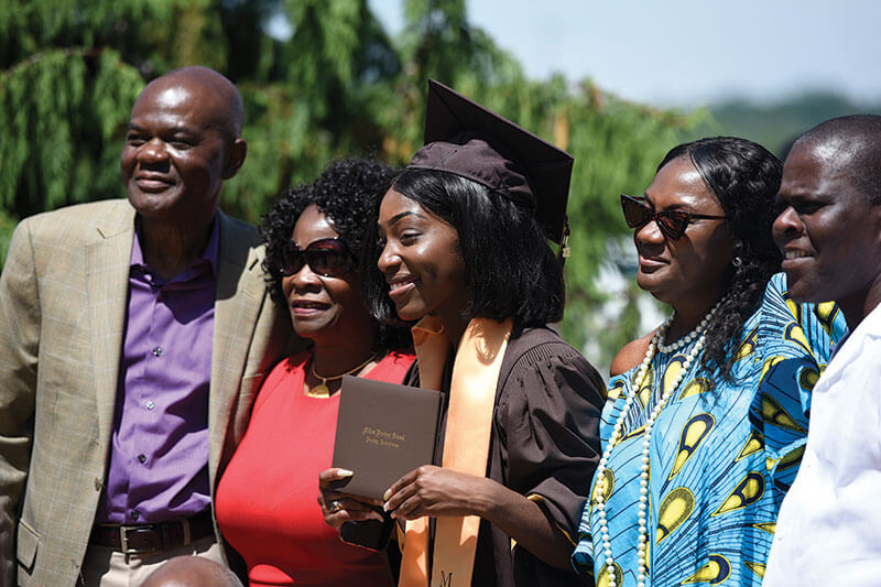 MHS student graduation photo with family.
