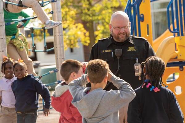 MHS Students with Police Officer on Playground