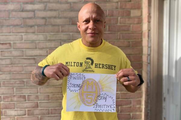 MHS Runner Holding Sign