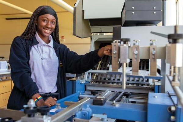 MHS Student Working With Machinery