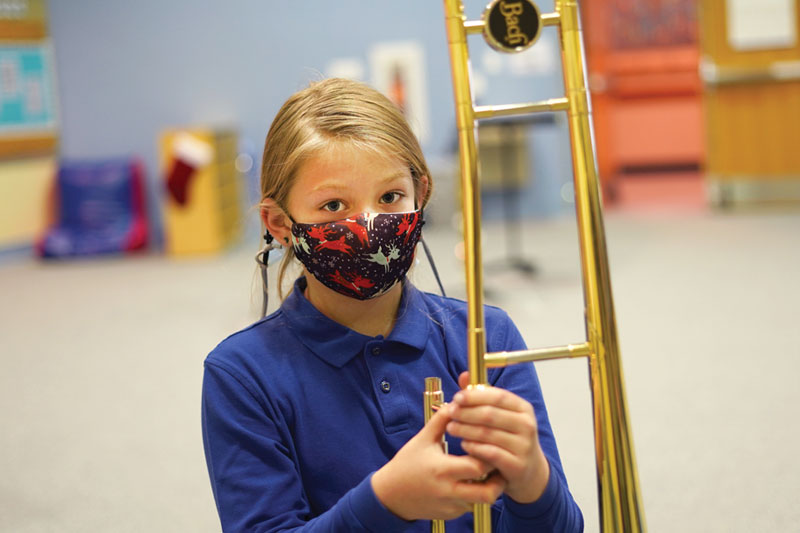 MHS student with her trombone in music class