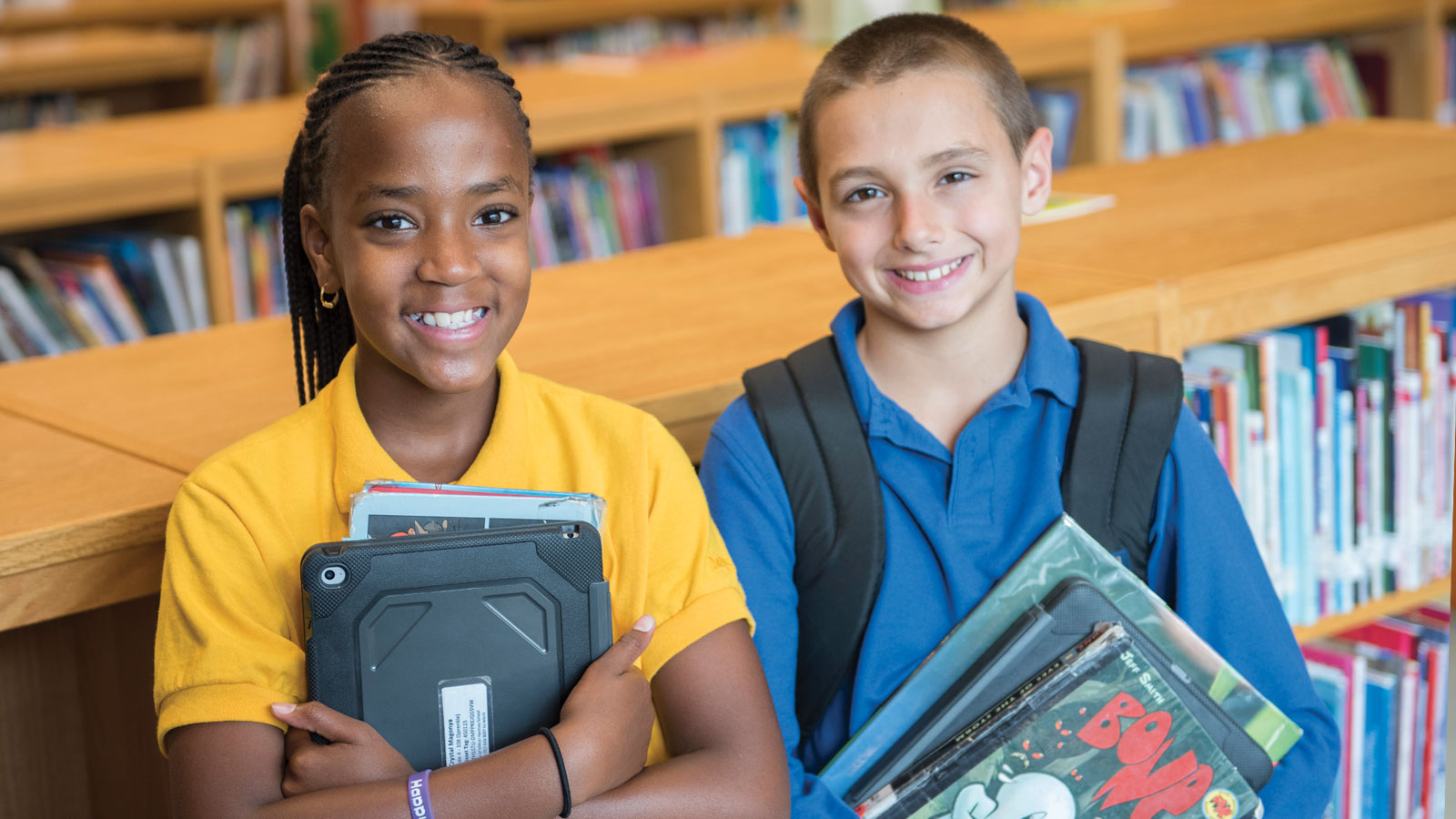 MHS students holding books at library