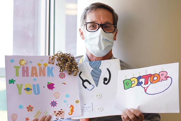 MHS doctor holding thank you cards