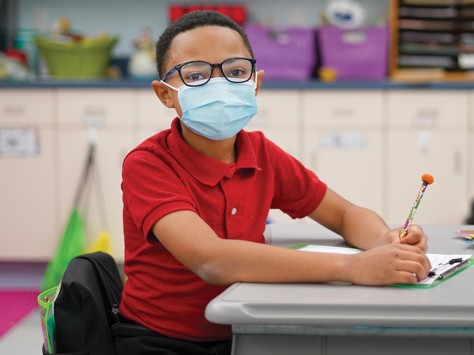 MHS student writing at a desk