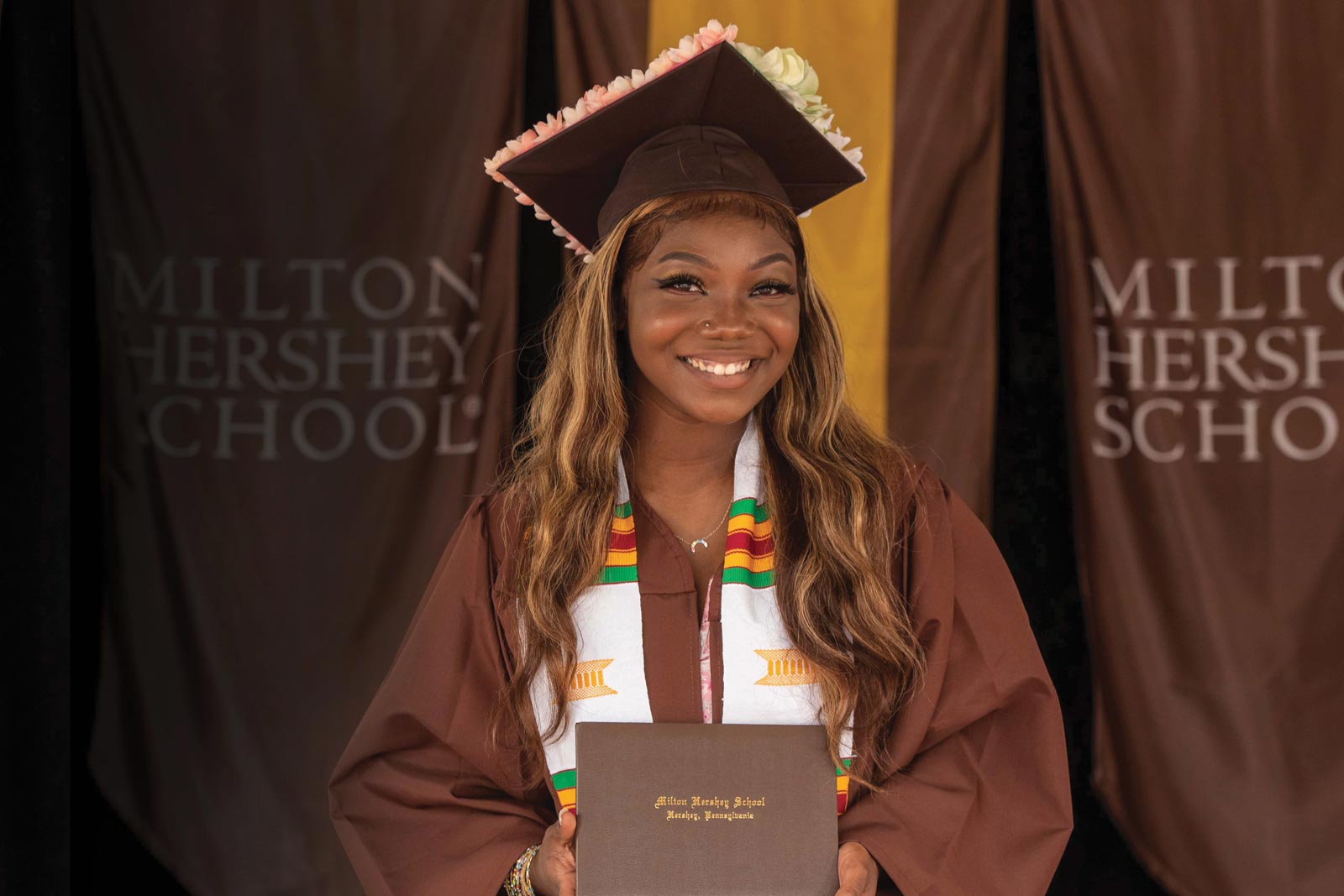 MHS student holding diploma