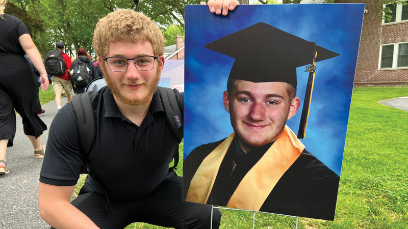 MHS student posing for photo with graduation photo