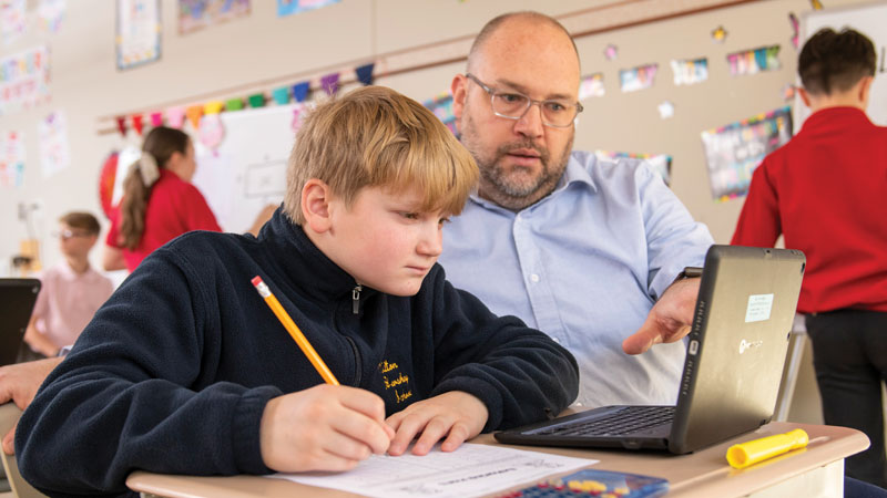 MHS teacher and student working at a computer together