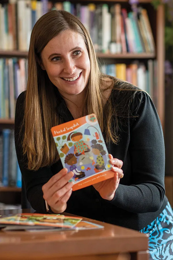 MHS staff member holding a book