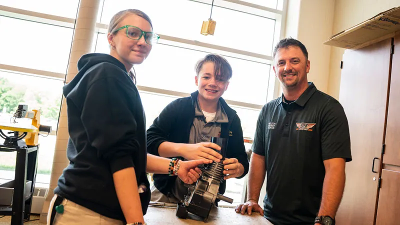 MHS students and teacher at a work bench