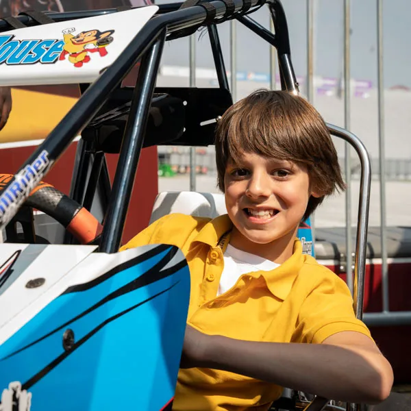 MHS student in a race car at a World of Outlaws event