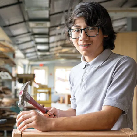 MHS student working with hammer