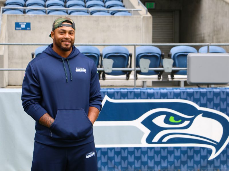 Garry Gilliam standing in front of a sign