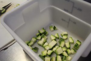 a white container with green pieces in it