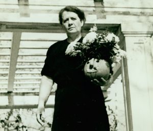 a person holding a pot and flowers