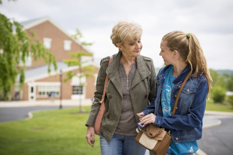 Grandmother walking outside with teenage girl MHS student.