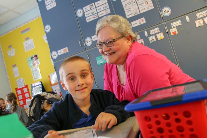 Parent or sponsor with MHS student in a classroom.