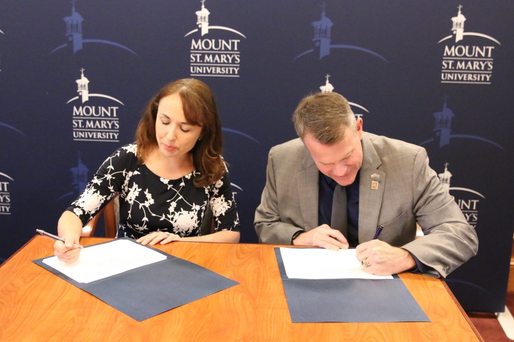 Leaders from MHS and Mount St. Mary's University sign memorandums of understanding