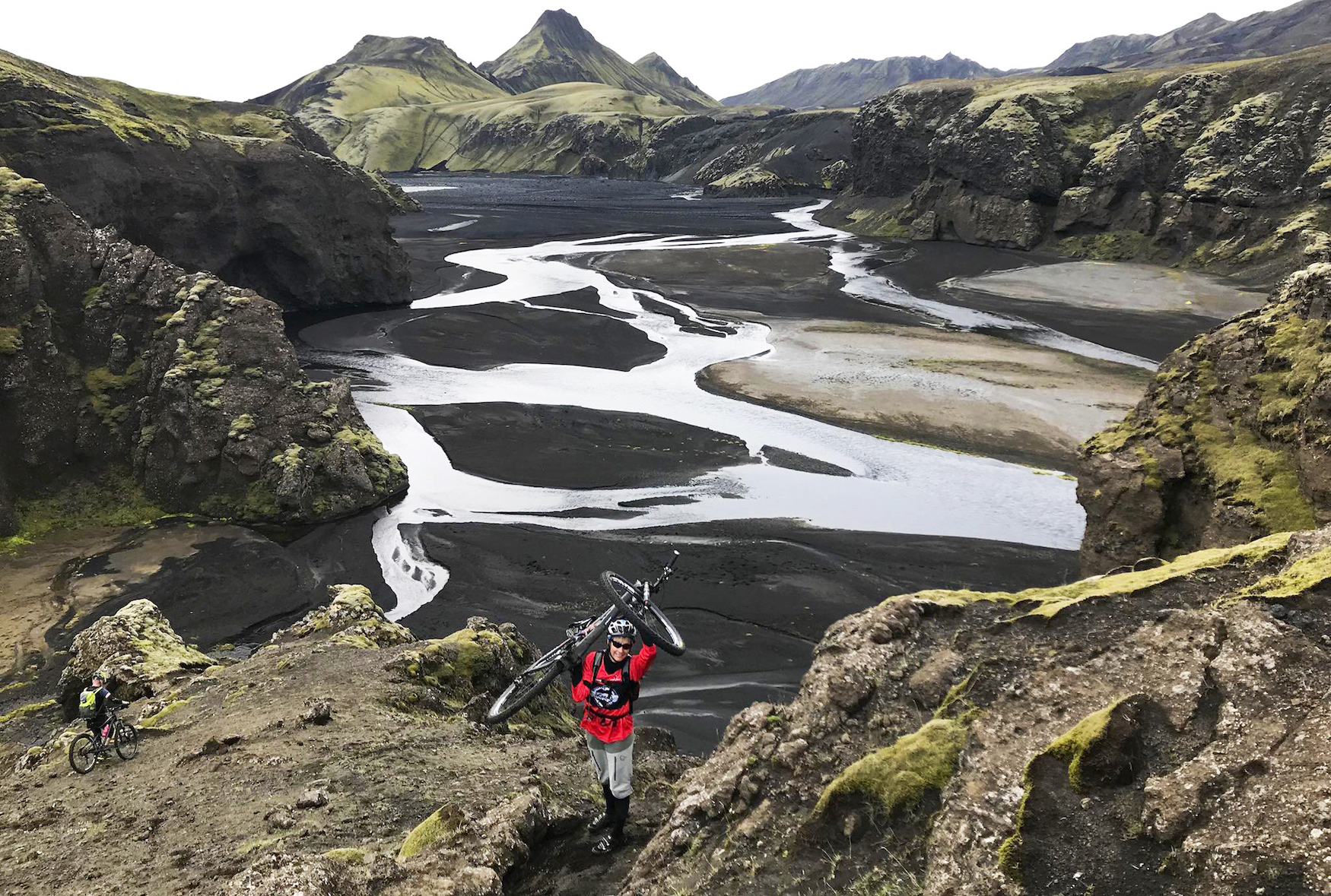 Sharon Henry, MHS teacher, carries her mountain bike uphill in Iceland.