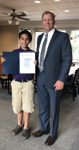 Dauphin County Commission Mike Pries congratulates MHS student Iziah on placing third in a diversity essay contest.