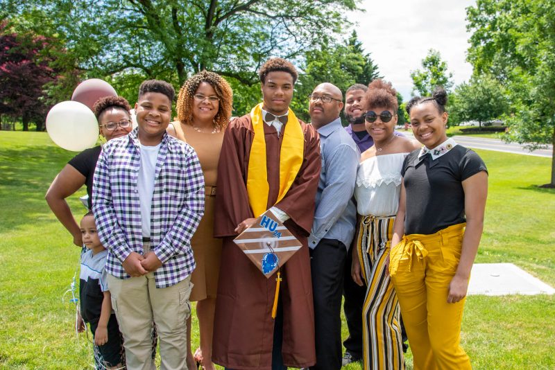 MHS graduate celebrating with family at 2020 commencement celebration