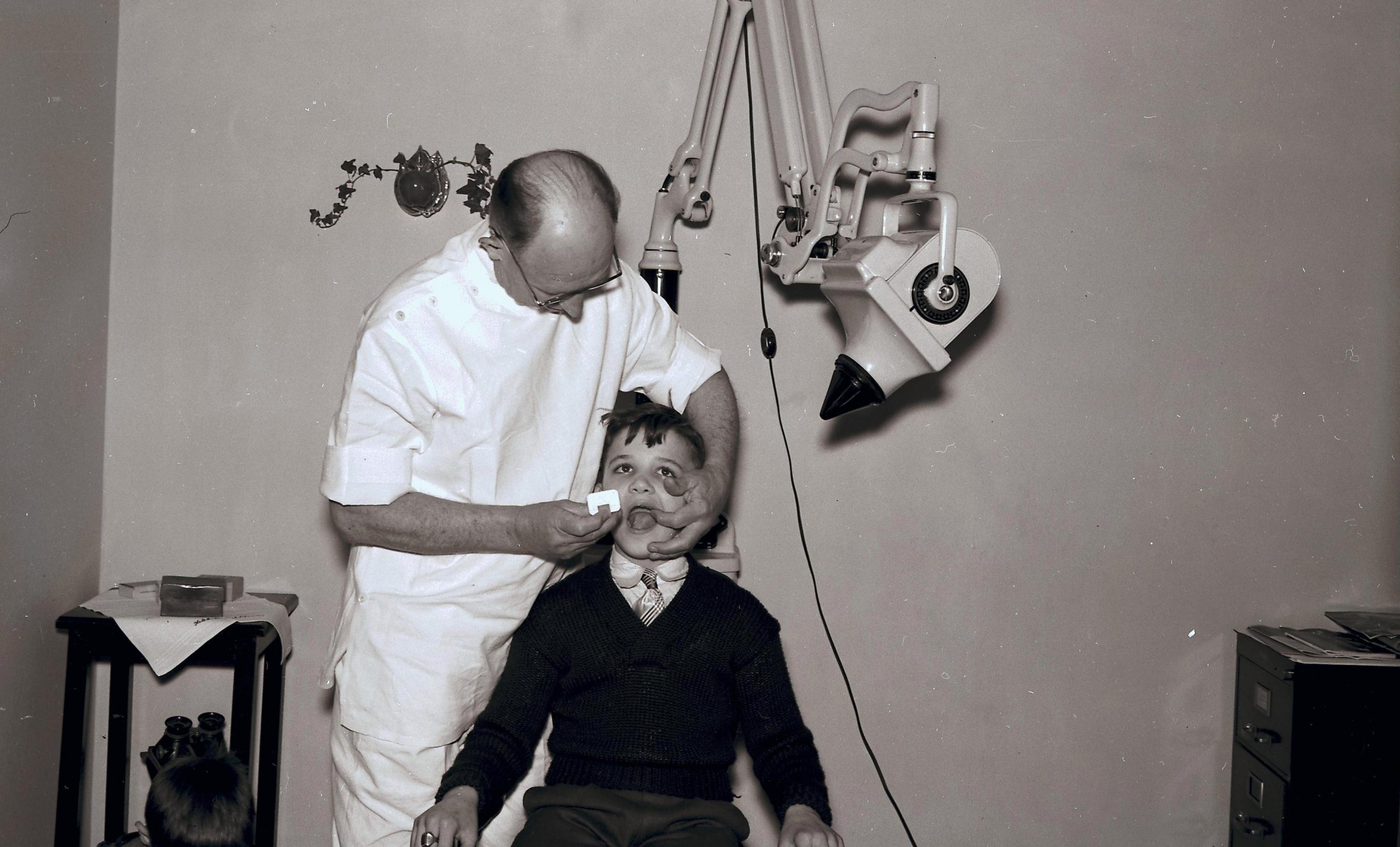 A student receives dental services in the early days of Milton Hershey School's dental program.
