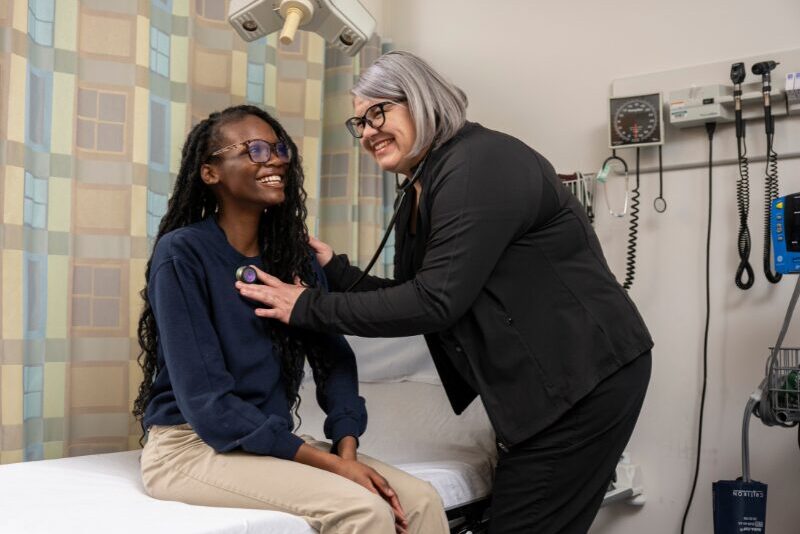 nurse checking a student's pulse