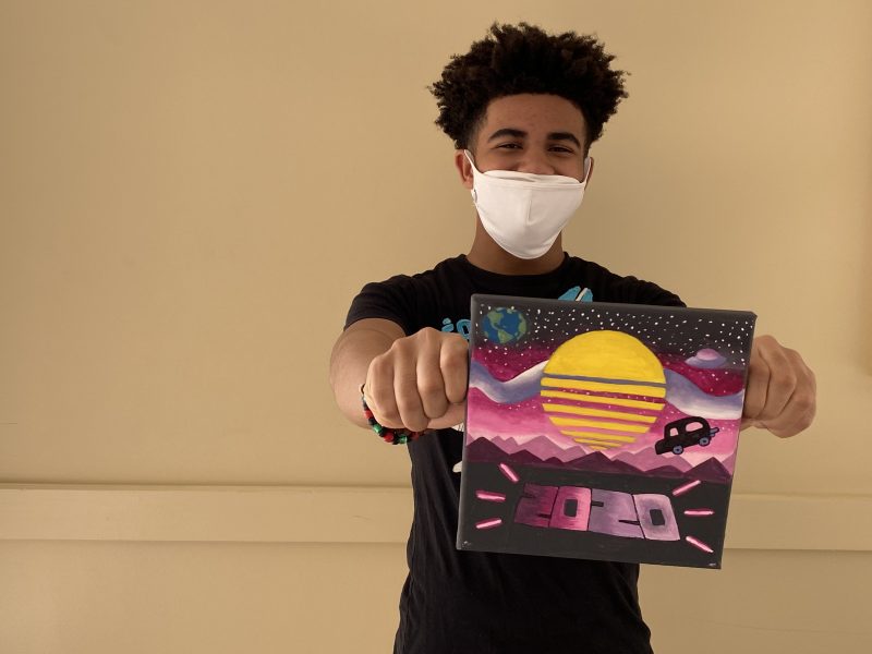 MHS student holding art canvas for FOCUS murals
