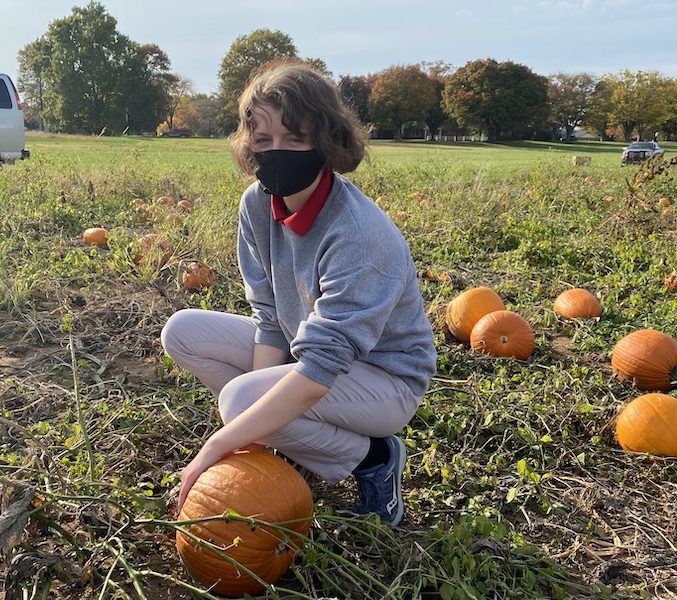 MHS student picking pumpkins