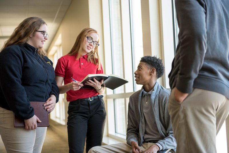 a group of people standing in a hallway