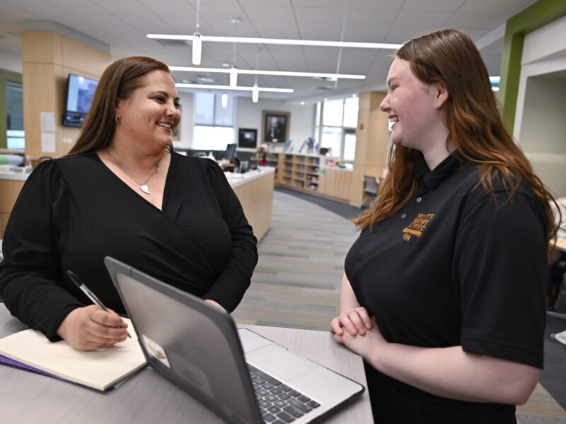 Staff and student communicate in Learning Resource Center