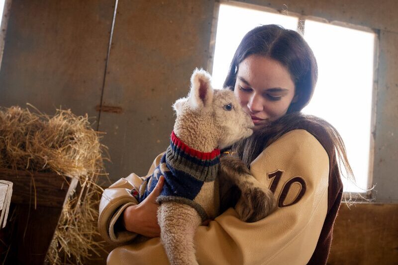 Agriculture student with a baby goat
