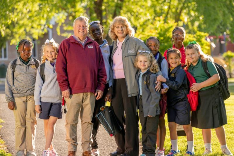 ED houseparents Greg and Julie Reese with their female students - walk to school