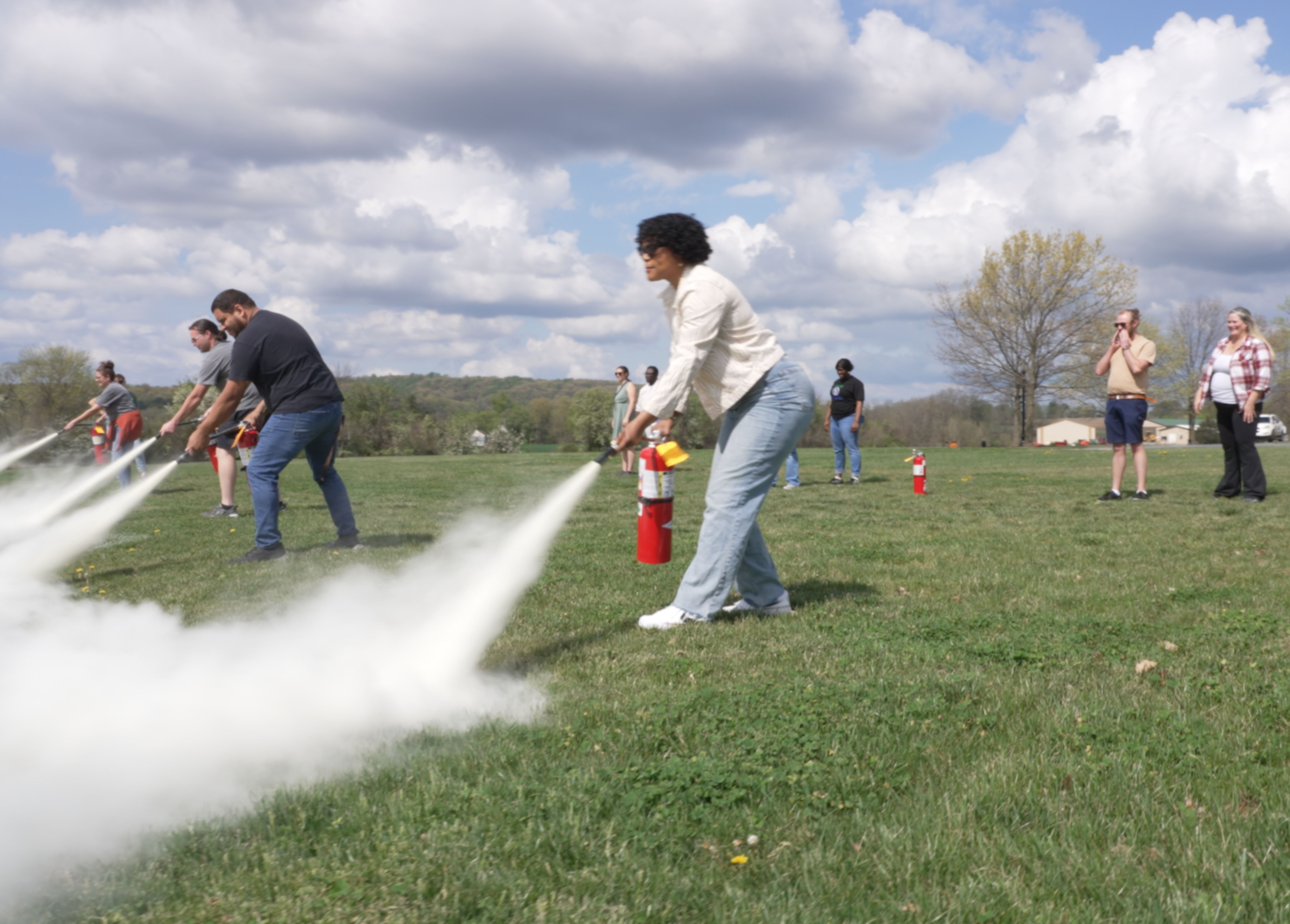 Houseparents outside receiving fire extinguisher training