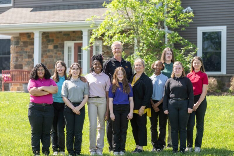 houseparents-with-students-outside-student-home