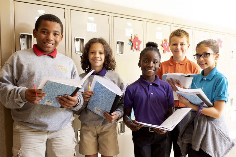 Middle school students with their notebooks enrolled at Milton Hershey School.