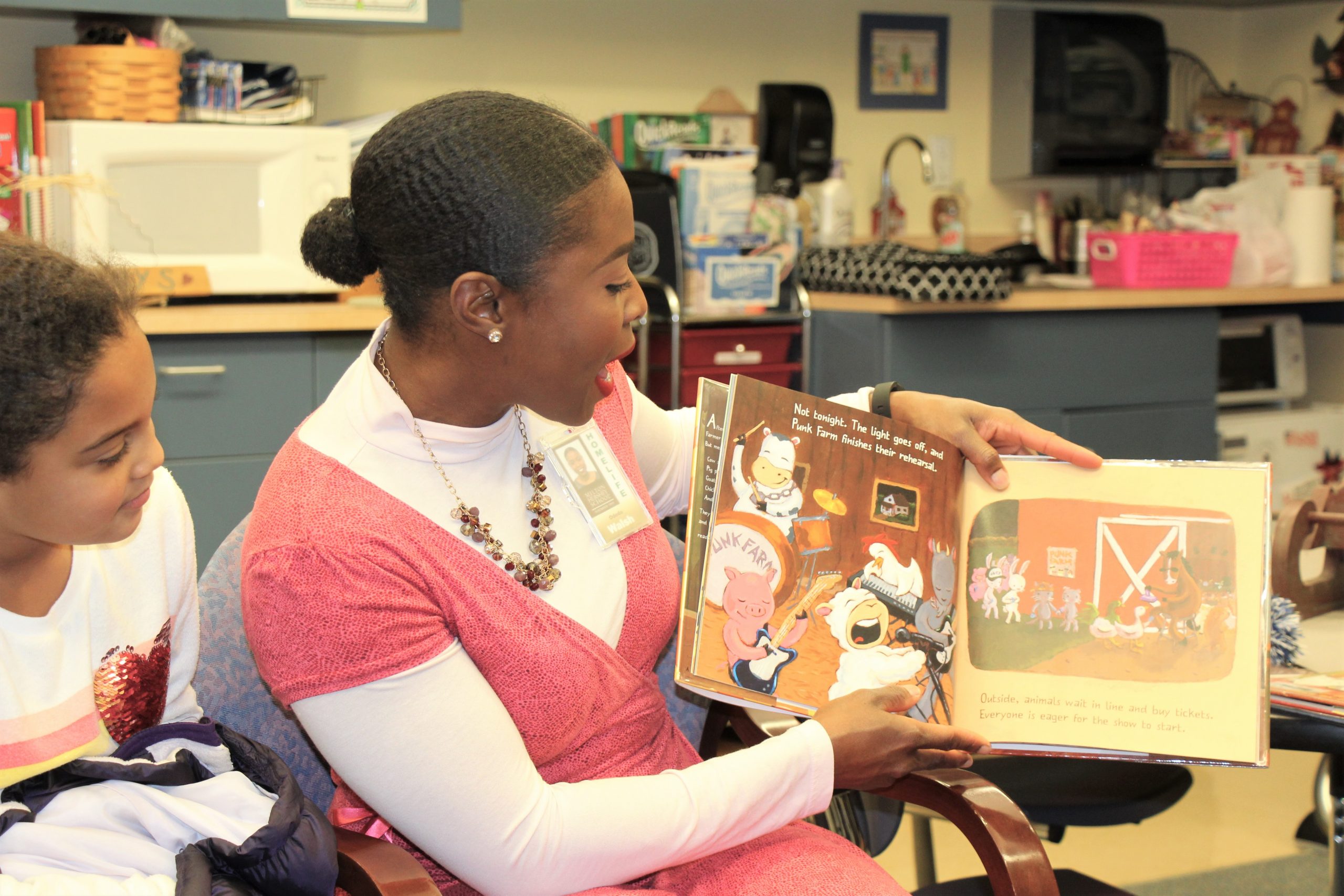 Milton Hershey School alumna and staff member Ododo Walsh ’98 reads to MHS students.