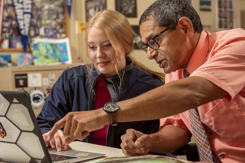 A Milton Hershey School College and Career Counselor works with a student on college plans.