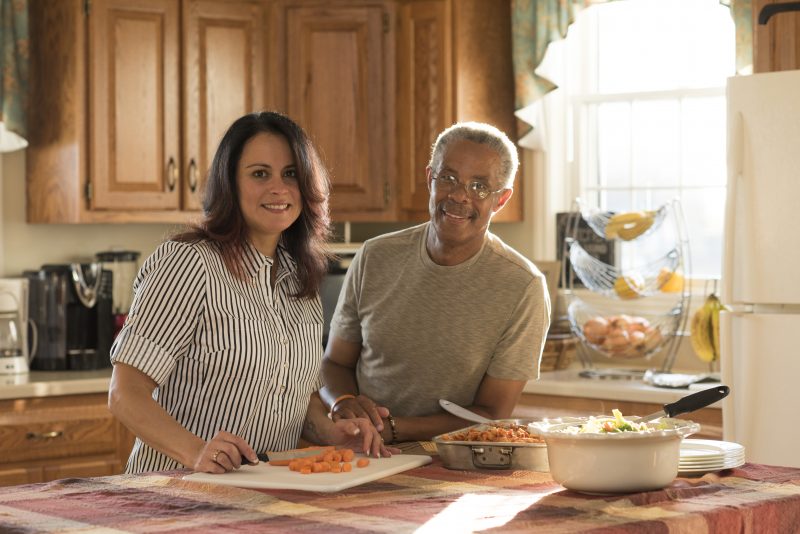 Milton Hershey School houseparent couple, Jonathan and Melissa Akers, prepare dinner in the kitchen of their student home.