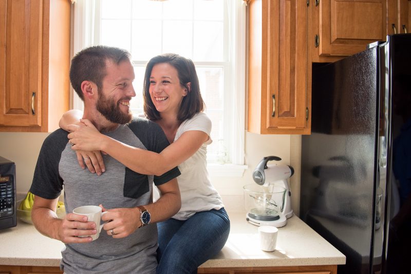 A Milton Hershey School houseparent couple pause for a photo in their student home kitchen.