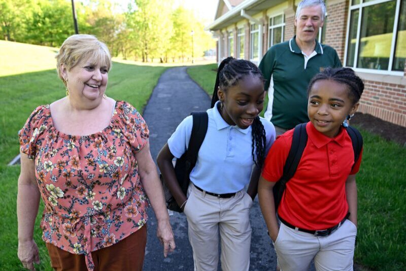 MHS houseparents walking elementary students to school in the morning
