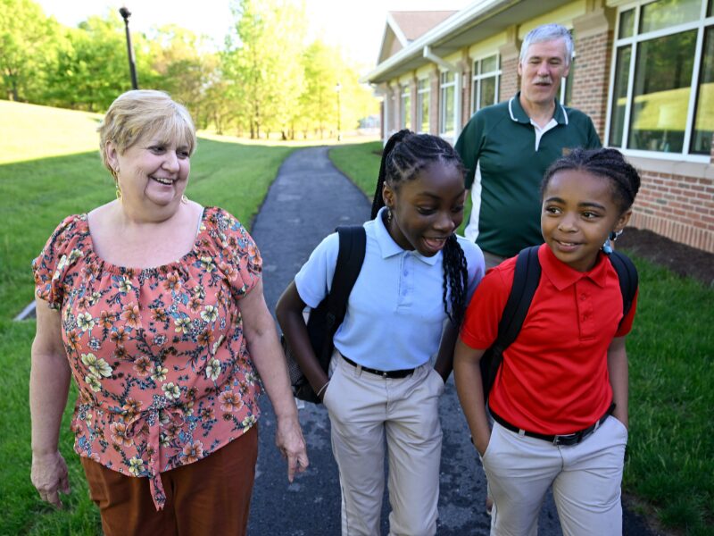 MHS houseparents walking elementary students to school in the morning