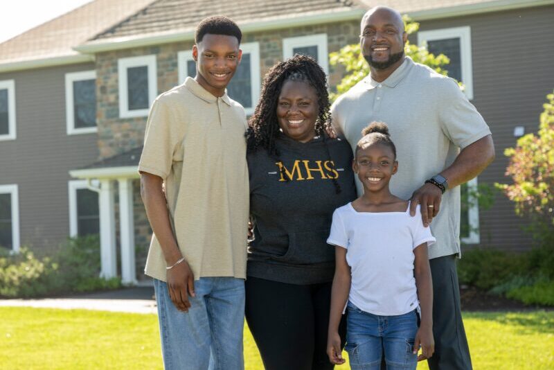 MHS houseparents with their personal children outside their student home