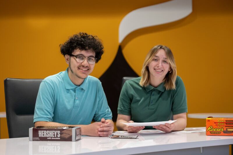 MHS student interns at The Hershey Company discussing packaging design