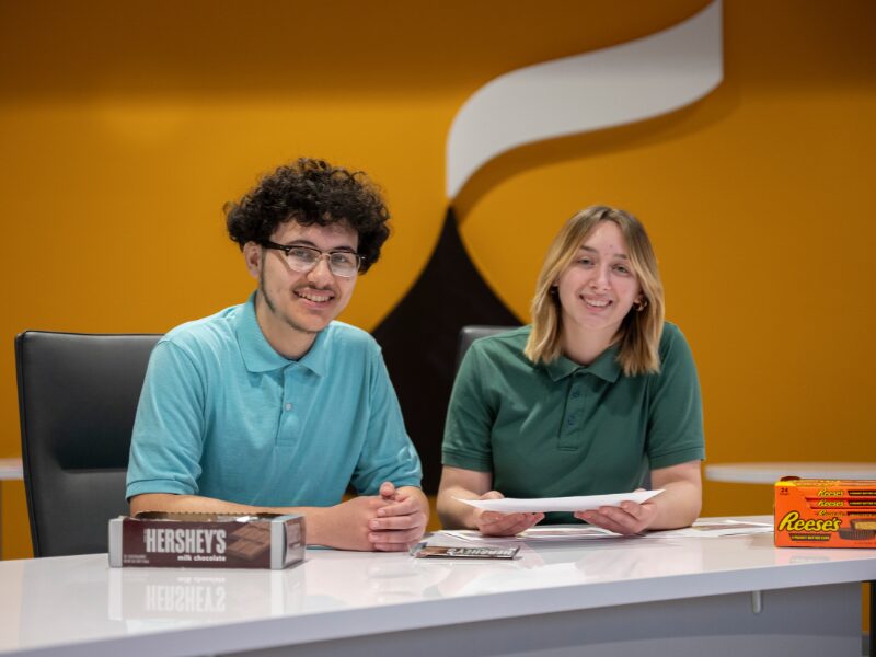 MHS student interns at The Hershey Company discussing packaging design