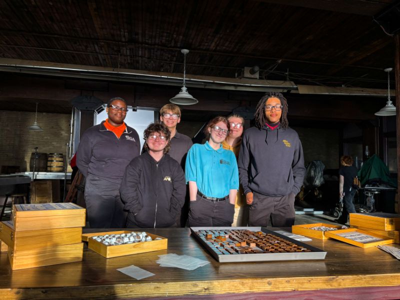 Select group of MHS senior division students visit HERSHEY movie set and pose with prop chocolate
