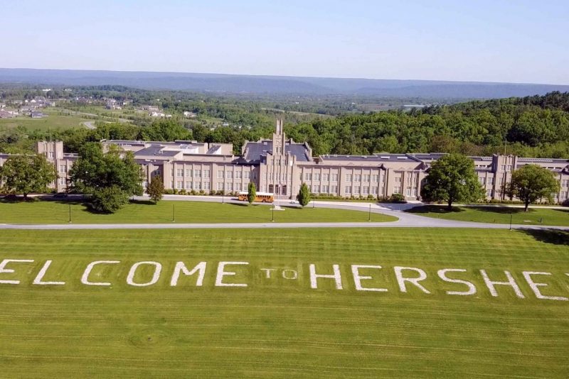 a large building with a lawn and words on it
