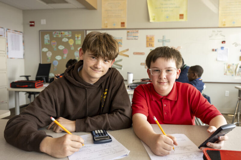 middle school boys working on math problems together